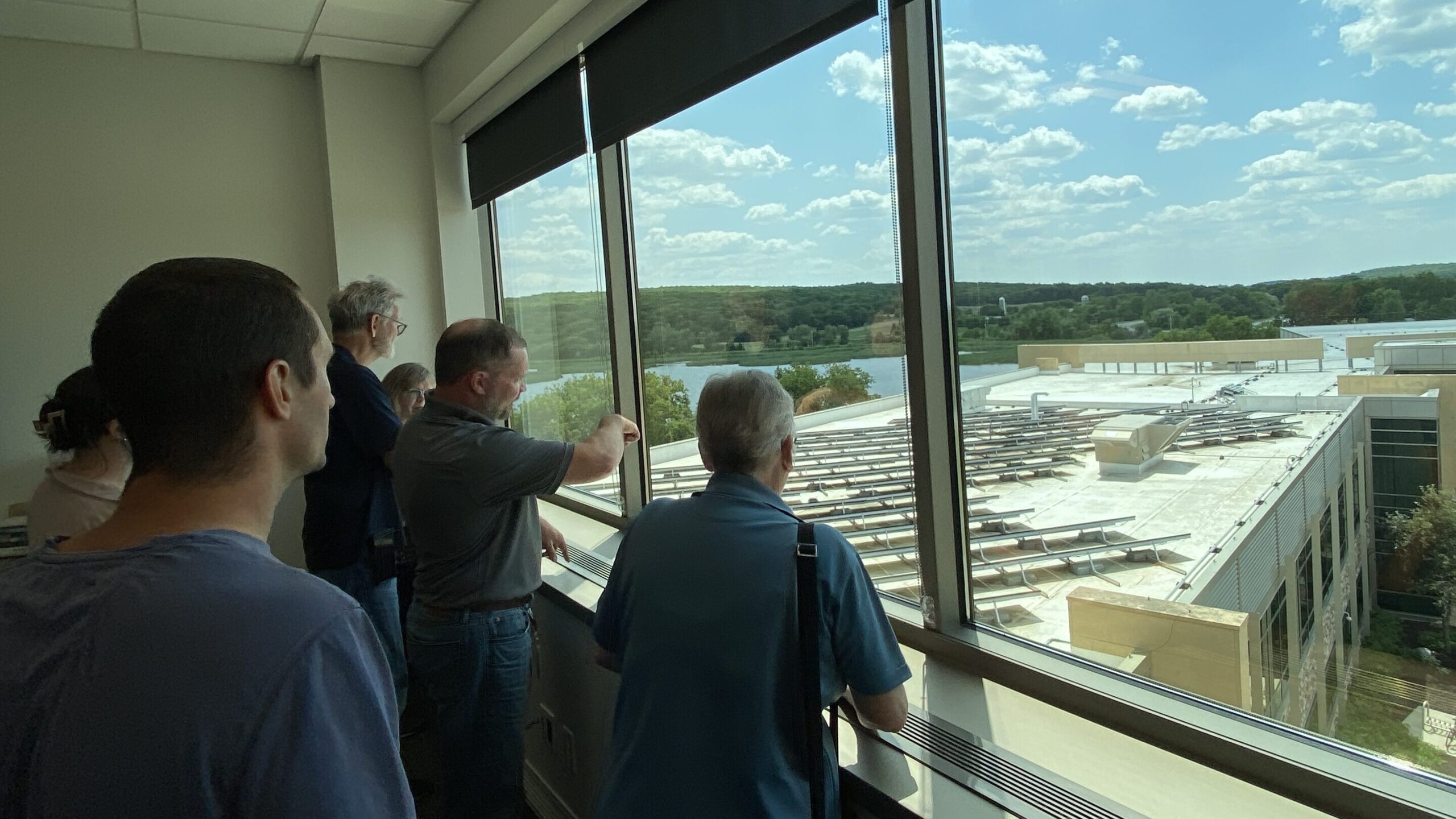 teachers over looking solar arrays in the roof of Blattner Energy