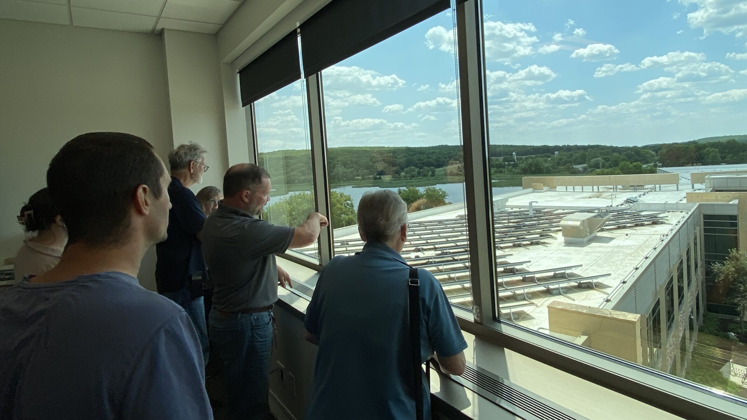 teachers over looking solar arrays in the roof of Blattner Energy 